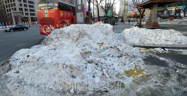 한파가 다시 시작된 8일 오전 도심 곳곳에 쌓아둔 눈이 녹지도 않고 치워지지도 않은 채 방치돼 흉물로 남아 있다. 사진은 서울 세종로 도로변에 쌓아둔 눈이 집채 만하다.<br />김명섭 기자 msiron@heraldcorp.com
한파가 다시 시작된 8일 오전 도심 곳곳에 쌓아둔 눈이 녹지도 않고 치워지지도 않은 채 방치돼 흉물로 남아 있다. 사진은 서울 세종로 도로변에 쌓아둔 눈이 집채 만하다.
김명섭 기자 msiron@heraldcorp.com