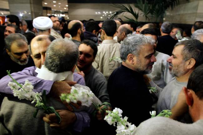 Iranian men who had been held hostage by Syrian rebels since early August congratulate each other as they arrive at a hotel in Damascus after being freed in a prisoner swap Wednesday.  AFP-Yonhap News