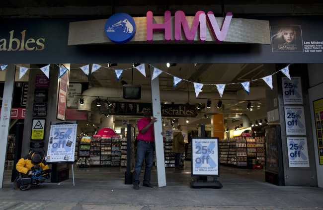 A worker opens a branch of HMV at the start of the day on Oxford Street in London, Tuesday.    AP-Yonhap News