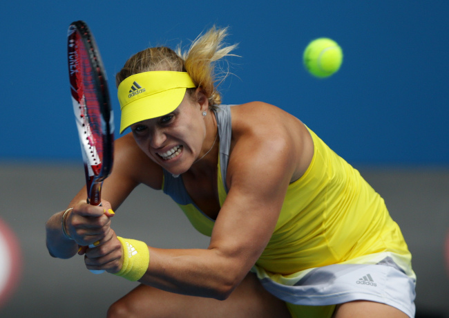 Germany’s Angelique Kerber hits a backhand return to Madison Keys of the U.S. during their third round match at the Australian Open tennis championship in Melbourne, Australia, Friday.   AP-Yonhap News