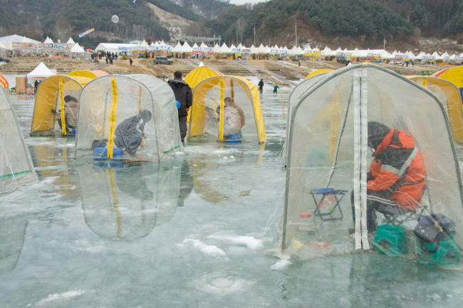 Visitors fish for smelt at a previous Inje Bingeo Fishing Festival.   (Inje Bingeo Fishing Festival)