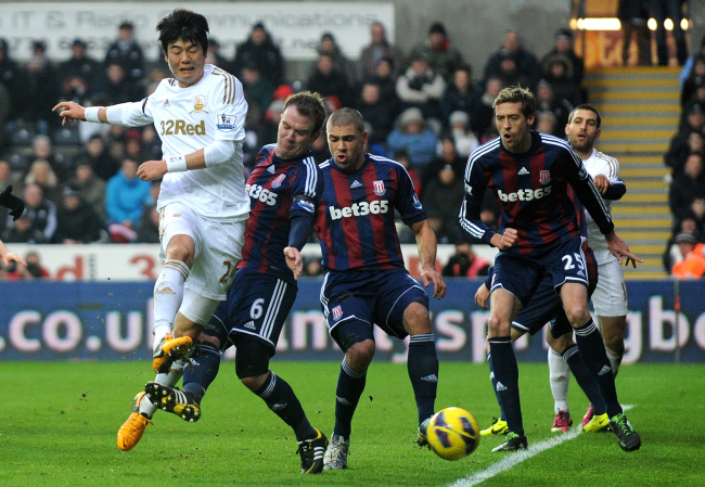 Swansea City’s Ki Sung-yueng attempts a shot on goal on Saturday.
Penta-Yonhap News