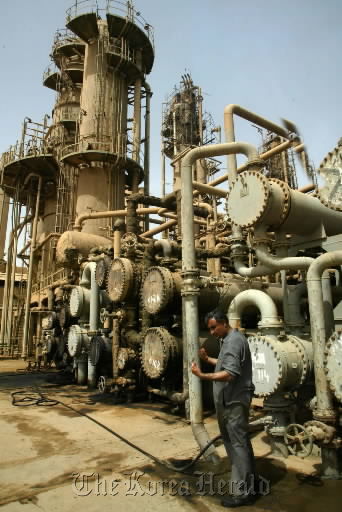 A mechanic works at the oil refinery in Baghdad, Iraq.   Bloomberg