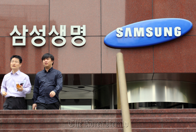 The logo of Samsung Life Insurance Co. is displayed outside the company’s headquarters in Seoul.   Bloomberg