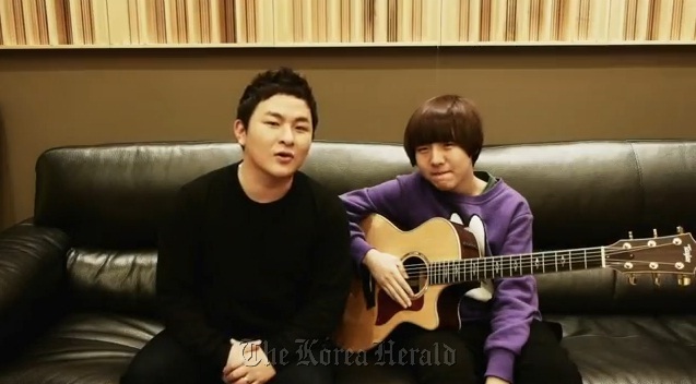 Singers Huh Gak (left) and Yoo Seung-woo are shown in a teaser of the “Mono Drama” music video.    YouTube