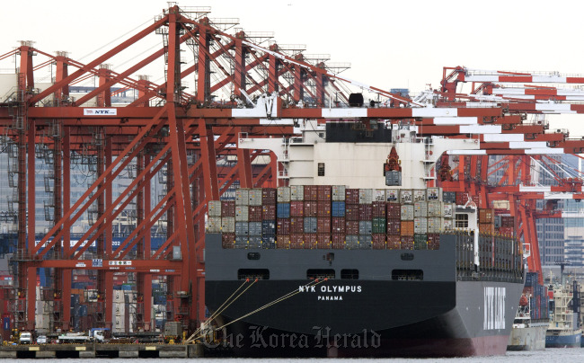 A Nippon Yusen K.K. container ship is moored at a shipping terminal in Tokyo.    Bloomberg