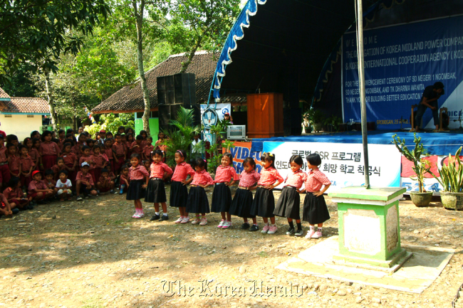 A group of students dances to celebrate the ground-breaking for construction of the second KOMIPO Elementary School in the Grobogan region in the central part of Java, Indonesia in April 2012.   KOMIPO
