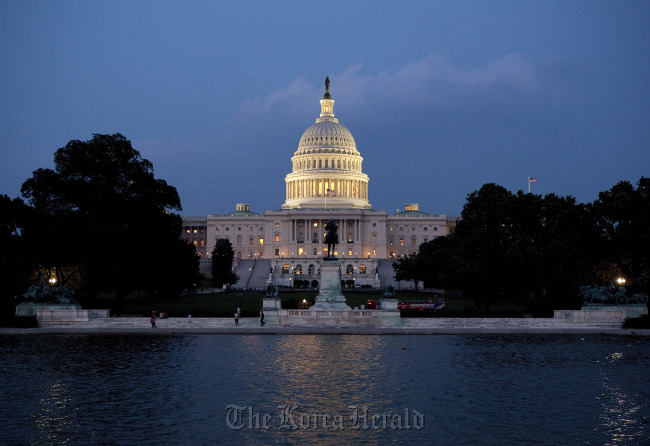 The U.S. Capitol building stands at night in Washington, D.C.   Bloomberg