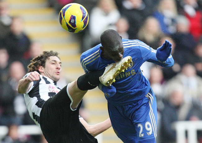 Newcastle United’s Fabricio Coloccini (left) and Chelsea’s Demba Ba challenge for the ball on Saturday.   AP-Yonhap News