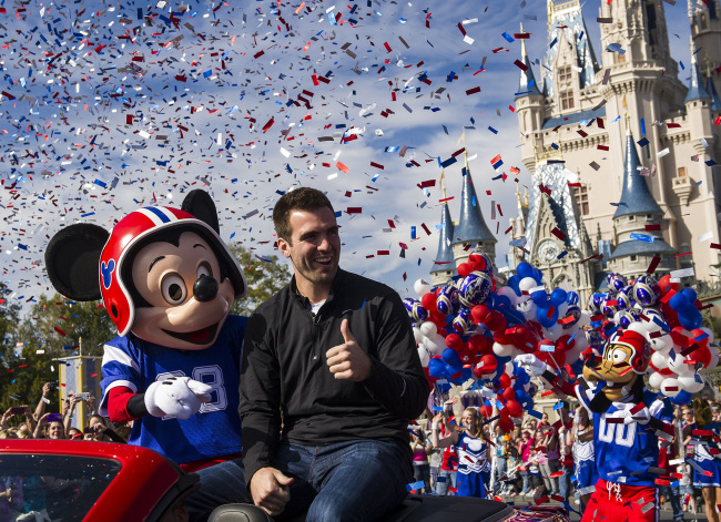 Super Bowl MVP Joe Flacco rides with Mickey Mouse during a parade at the Walt Disney World Resort in Lake Buena Vista, Florida, Monday.   AP-Yonhap News