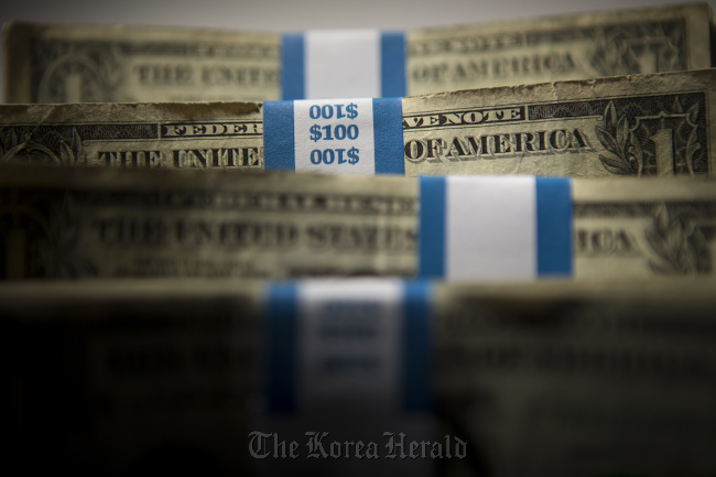 Stacks of U.S. $1 bills.    Bloomberg
Stacks of U.S. $1 bills.    Bloomberg