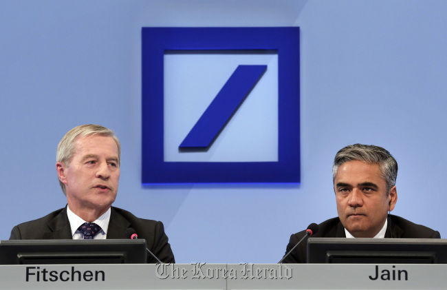 Joint CEOs Juergen Fitschen (left) and Anshu at Deutsche Bank’s annual news conference in Frankfurt.    Bloomberg