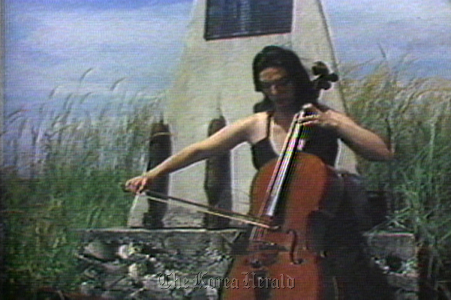 A scene from “Guadalcanal Requiem,” a video work by Nam June Paik with Charlotte Moorman.    Nam June Paik Art Center