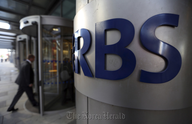 A visitor enters the headquarters of the Royal Bank of Scotland Group in London.   Bloomberg