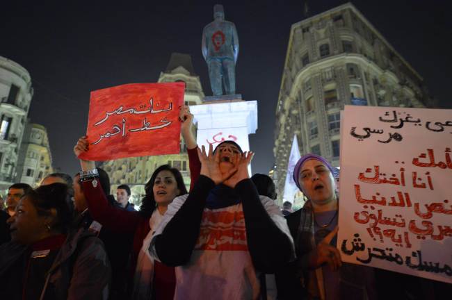Egyptian protesters hold up placards during a demonstration in Cairo on Tuesday.   AFP-Yonhap News