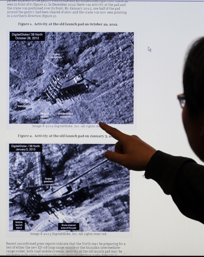 An analyst observes a satellite picture of the rocket launch pad in Musudan-ri, North Korea released by 38 North, an American internet analysis site that specializes in North Korea.   Yonhap News