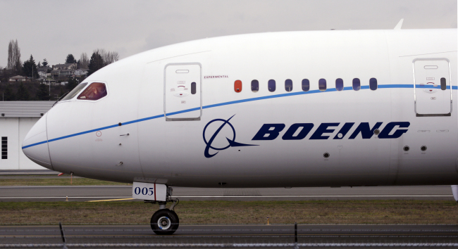 A pilot waves to bystanders while taxiing after landing a Boeing 787 flight test jet following a test flight on Feb. 11.   AP-Yonhap News