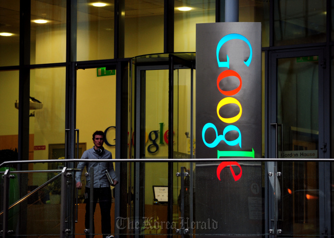 A pedestrian exits Gordon House, the current European headquarters of Google Inc. on Barrow Street in Dubin, Ireland.   Bloomberg