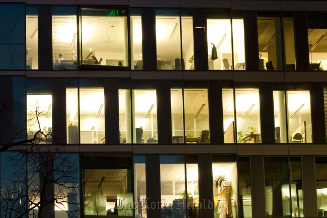 Office building windows with lights on   123RF