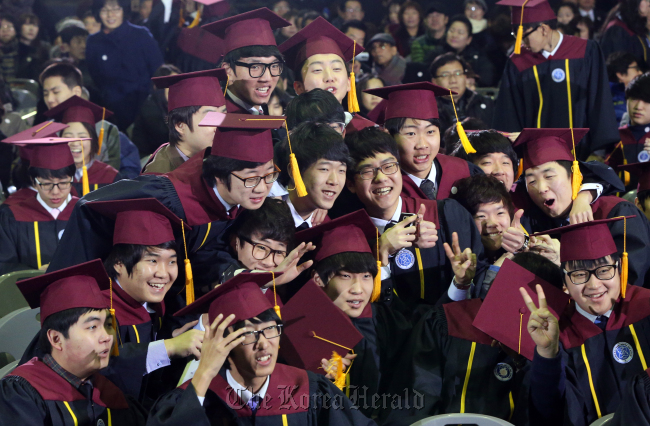Seniors of Incheon Electronic Meister High School pose for a group photo after their graduation ceremony on Feb. 7. Yonhap News