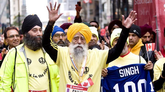'Turbaned Tornado' Fauja Singh, 101, began running at age 89 and has since completed nine marathons. Above, Sigh crosses the finish line at the Toronto Marathon in 2011. (AFP)