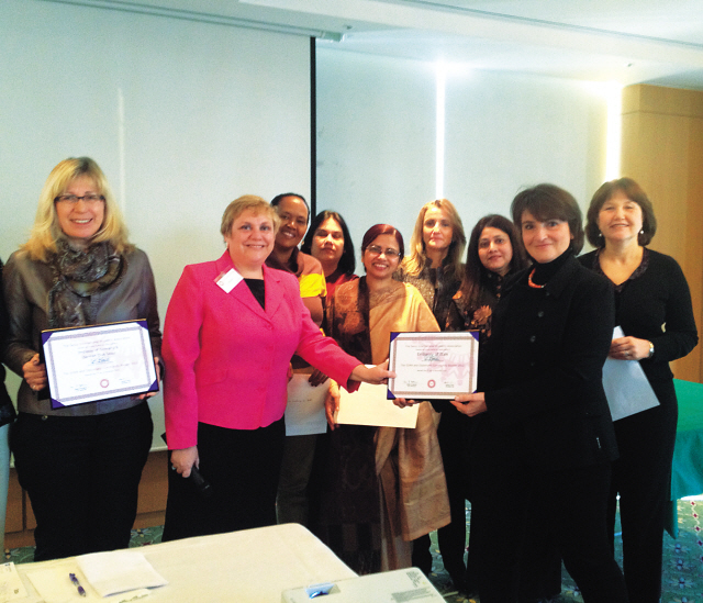 Seoul International Women’s Association president Terri Hartman (second from left) holds a certificate of appreciation with Maria Mercuri (second from right) of Italy, during SIWA’s morning coffee meeting at Seoul Club, Wednesday. From left are: Veronkia Ingeborg Hofmann of Germany; Hartman; Monicah Wangari Ngovi of Kenya; Neelam Prakash of India; Jesmeen Islam of Bangladesh; Amal Lahlou of Morocco; Kauser Shaukat Ali Mukadam of Pakistan; Mercuri; and Sibel Iscan of Turkey. (Philip Iglauer/The Korea Herald)