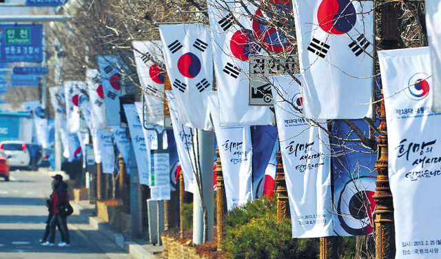 Taegeukgi, the national flag of South Korea, and commemorative flags adorn the trees in front of the
National Assembly, Yeouido, Seoul, where the presidential inauguration takes place Monday. (Yonhap News)