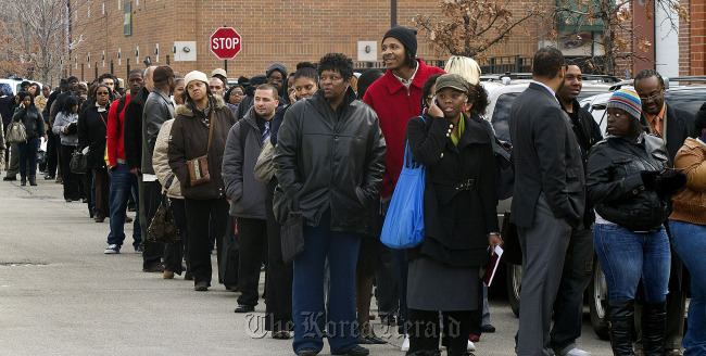 Job seekers stand in line to enter the City of Chicago job fair at Kennedy King College in Chicago, Illinois.   Bloomberg