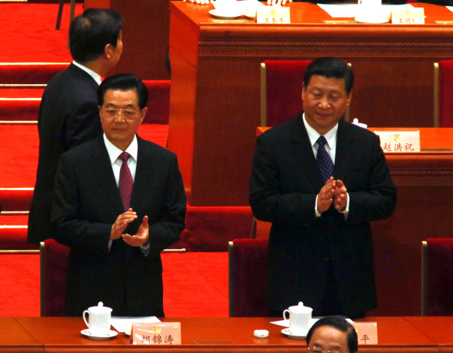 China’s President Hu Jintao (left) and the country’s new leader Xi Jingping attend the opening of the Chinese People’s Political Consultative Conference in the Great Hall of the People in Beijing on Sunday.   UPI-Yonhap News