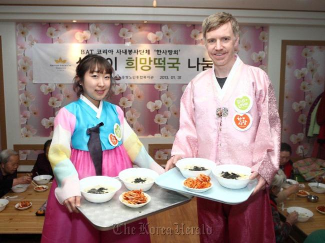 Member employees of Big Love, a volunteer service organization run by BAT Korea officials, serve food for the elderly in a district-run senior welfare community in January.    BAT Korea