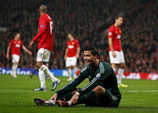 Real Madrid's smiles as he sits on the pitch during their Champions League round of 16 soccer match at Old Trafford Stadium, Manchester, England, Tuesday, March 5, 2013. Real won the match 2-1 to beat Manchester United 3-2 on aggregate.