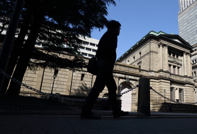 A man walks past the Bank of Japan headquarters in Tokyo, Japan, on Thursday, Feb. 28, 2013. Japanese Prime Minister Shinzo Abe nominated Asian Development Bank President Haruhiko Kuroda to lead the nation's central bank, raising the likelihood of further monetary stimulus this year. Photographer: Tomohiro Ohsumi/Bloomberg
A man walks past the Bank of Japan headquarters in Tokyo.    Bloomberg