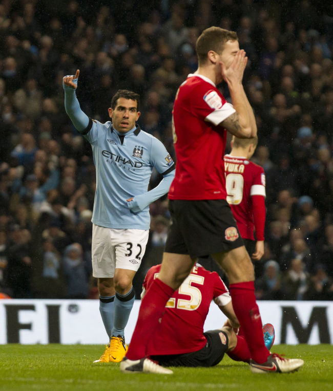 Manchester City’s Carlos Tevez (left) celebrates after scoring his third goal against Barnsley during their English FA Cup quarterfinal soccer match at The City of Manchester Stadium in England on Saturday.   AP-Yonhap News