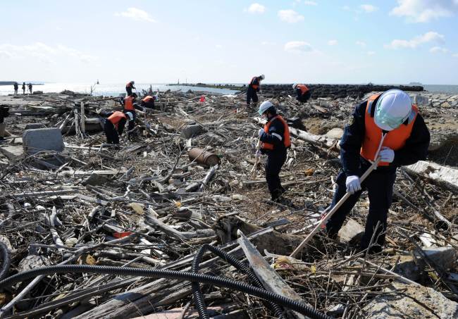 <YONHAP PHOTO-1114> Police officers search for tsunami victims two years after at the estuary of the Kyu Kitakami river in Ishinomaki, Miyagi prefecture on March 11, 2013. Japan on March 11 marked the second anniversary of a ferocious tsunami that claimed the lives of 15,881 people, with 2,668 others remaining unaccounted for, and sparked the worst nuclear accident in a generation. AFP PHOTO / TOSHIFUMI KITAMURA../2013-03-11 15:08:02/ <저작권자 ⓒ 1980-2013 ㈜연합뉴스. 무단 전재 재배포 금지.>
Police officers search for tsunami victims two years after, at the estuary of the Kyu Kitakami river in Ishinomaki, Miyagi prefecture on Monday. AFP-Yonhap News