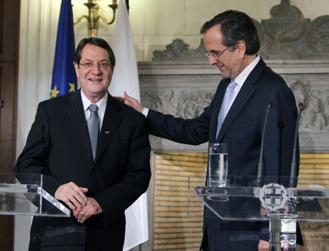 Greek Prime Minister Antonis Samaras (right) with recently-elected Cypriot President Nicos Anastasiades after a news conference at his official residence in Athens on Monday.     AP-Yonhap News