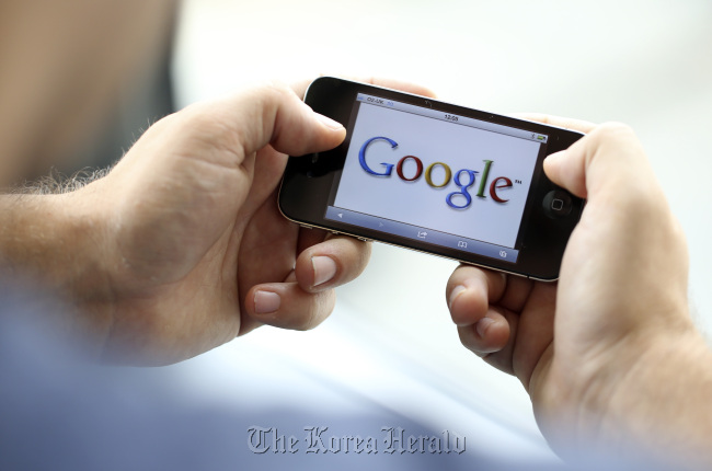 The Google Inc. logo is seen on an Apple Inc. iPhone 4 in London.   Bloomberg