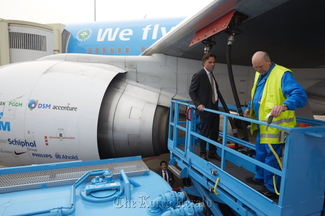 Workers supply biofuel to the KLM Royal Dutch airplane.   KLM