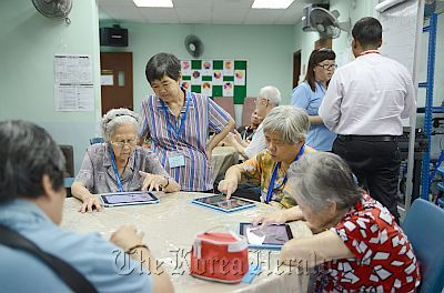 At AWWA Elderly Services in Ang Mo Kio, elderly clients use iPads.   The Star