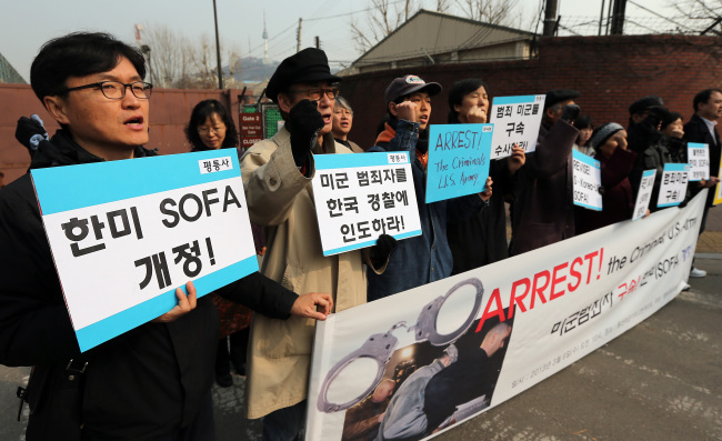 Members of civic group Solidarity for Peace and Reunification of Korea protest outside the U.S. Army Garrison Yongsan in Seoul, demanding revisions to SOFA. Yonhap News