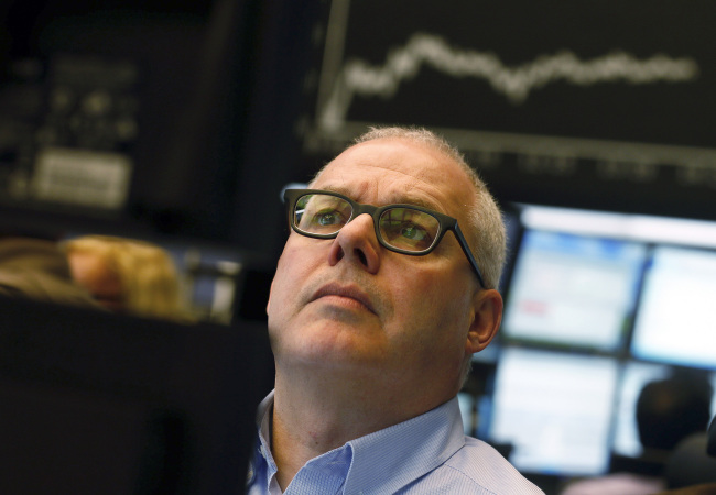 A trader monitors financial data on his computer screens beneath a display of the DAX Index curve at the Frankfurt Stock Exchange in Frankfurt, Germany, on Monday, March 18, 2013. The euro weakened to its lowest level this year, while stocks and commodities slumped, as an unprecedented levy on Cyprus's bank savings threatened to throw Europe back into crisis. Photographer: Ralph Orlowski/Bloomberg
A trader monitors financial data on his computer screens beneath a display of the DAX Index curve at the Frankfurt Stock Exchange in Frankfurt on Monday.   Bloomberg
