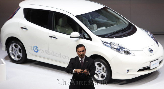 Carlos Ghosn, president and chief executive officer of Nissan Motor Co., speaks in front of the company’s Leaf electric vehicle during a news conference at the company’s headquarters in Yokohama City, Kanagawa Prefecture, Japan, in June 2011.   Bloomberg