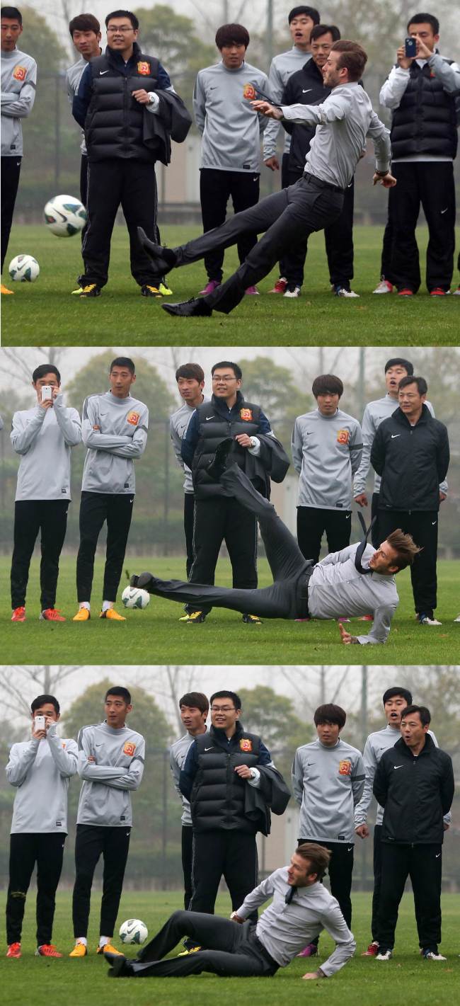 OOPS: Soccer star David Beckham slips while showing how to take a free kick during a visit to Zall soccer club in Wuhan, China, Saturday.   AFP-Yonhap News