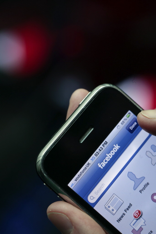 The Facebook Inc. logo is seen on an Apple Inc. iPhone in London.  Bloomberg