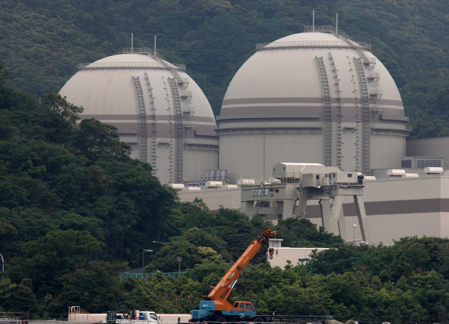 Two nuclear reactors stand at Kansai Electric Power Co.’s Ohi nuclear power station in Ohi Town, Fukui prefecture, Japan.    Bloomberg