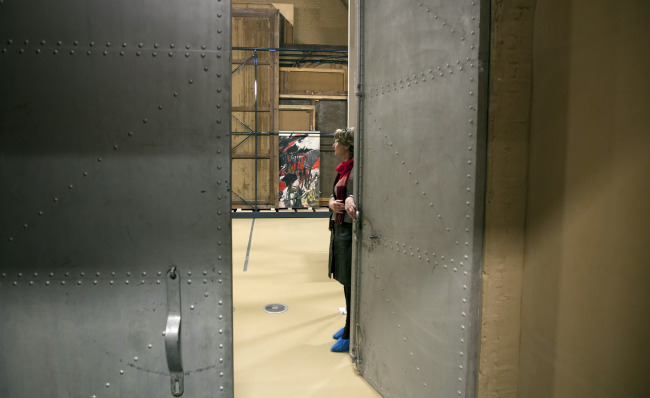 Press and communications officer Veronique Van Passel opens giant steel doors which lead to an interior warehouse in the Antwerp Royal Museum of Fine Arts in Antwerp, Belgium, Thursday.   AP-Yonhap News