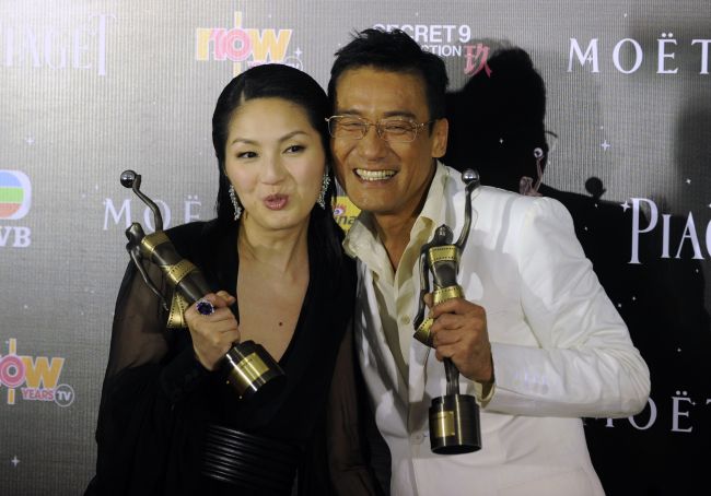 Hong Kong actress Miriam Yeung (left) holds the best actress award for the movie “Love in the Buff” and Hong Kong actor Tony Leung Ka Fai holds the Best Actor award for the movie “Cold War” during the 32nd Hong Kong Film Awards on Saturday.   AFP-Yonhap News