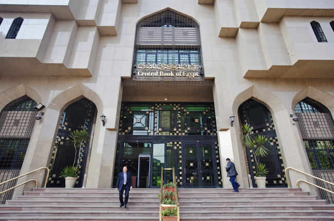 Pedestrians use the stairs outside of Egypt’s central bank in Cairo.    Bloomberg