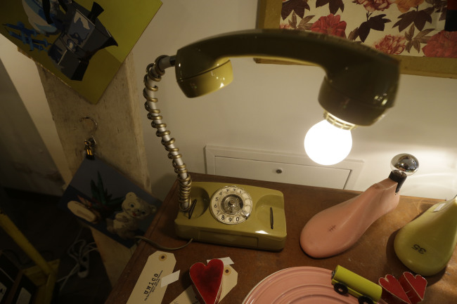 A table lamp made from an old telephone is displayed at the “Unico” showroom during the Milan Design Fair in Italy on April 11.   AP-Yonhap News