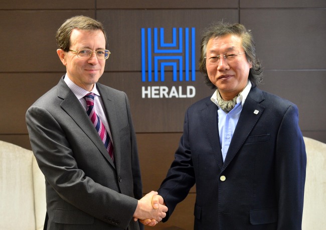 French Ambassador to Korea Jerome Pasquier (left) and Lee Young-man, CEO and publisher of The Korea Herald, shake hands during a courtesy visit by the ambassador to Lee’s office in Seoul on Wednesday.   Lee Sang-sub/The Korea Herald