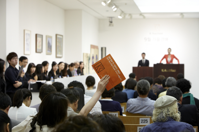 An auction is underway at K-Auction in this file photo.    K-Auction